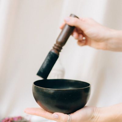 Soft focus image of hands in a meditative mudra pose.